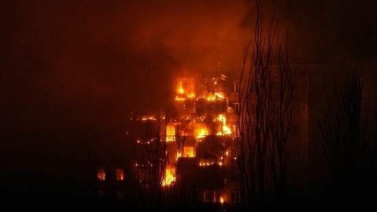 A fire burns at an apartment building after it was hit by the shelling of a residential district in Mariupol, Ukraine.(AP) A fire burns at an apartment building after it was hit by the shelling of a residential district in Mariupol, Ukraine.(AP)