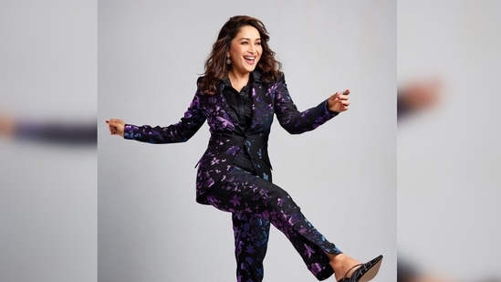 Madhuri Dixit struck a happy dancing pose for the camera with her hands and feet up in the air and wore a million-dollar smile on her face.(Instagram/@madhuridixitnene)