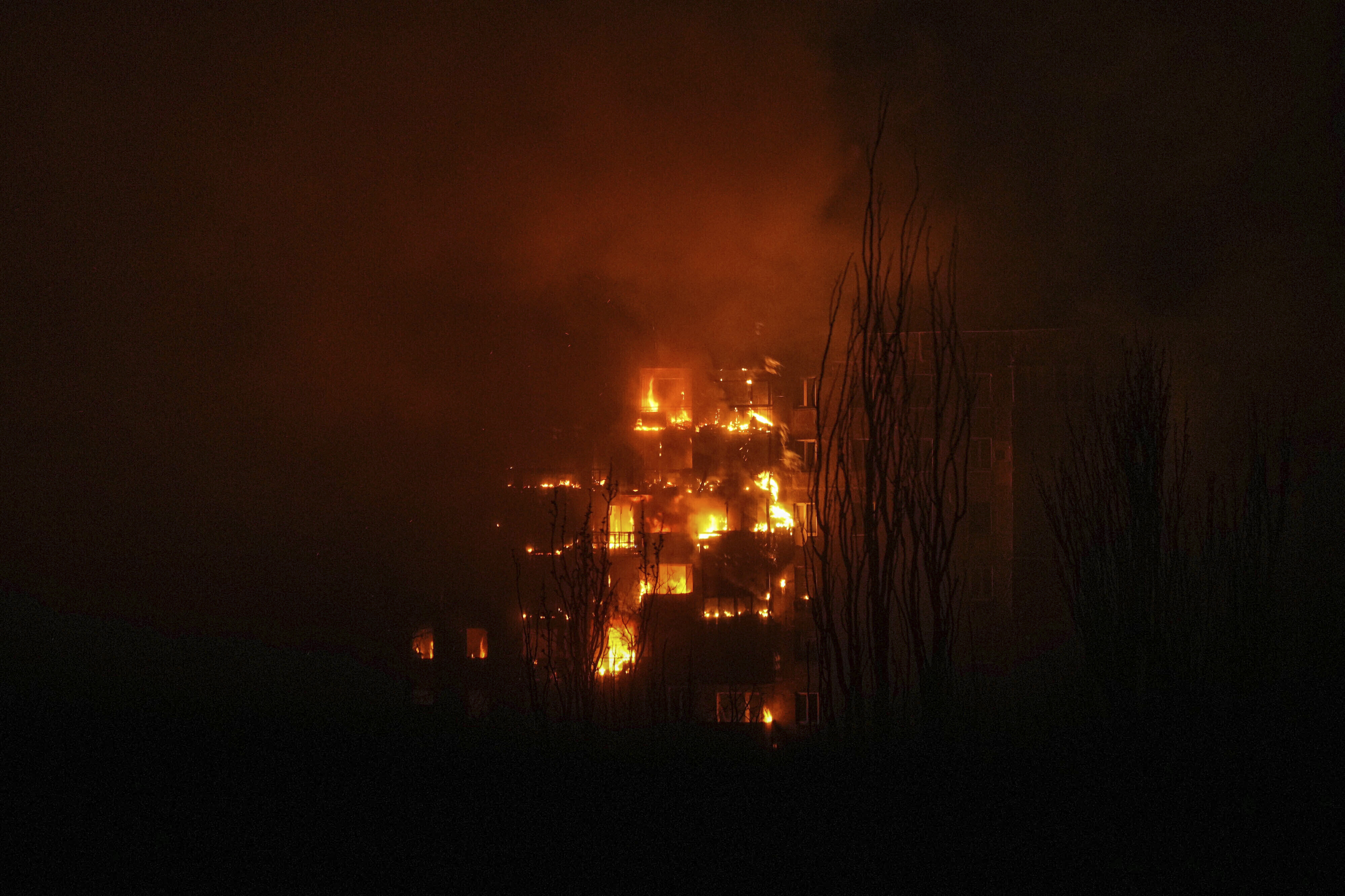A fire burns at an apartment building after it was hit by the shelling of a residential district in Mariupol, Ukraine. (AP) A fire burns at an apartment building after it was hit by the shelling of a residential district in Mariupol, Ukraine. (AP)