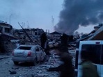 Smoke rises amid damaged buildings and vehicles following an attack on the Yavoriv military base, in Yavoriv, Lviv Oblast, Ukraine on March 13, 2022.