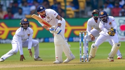 Indian batter Virat Kohli plays a shot as Sri Lanka fielder attempts for a catch during the first day of 2nd test match between India and Sri Lanka, at Chinnaswamy Stadium in Bengaluru, Saturday (PTI) Indian batter Virat Kohli plays a shot as Sri Lanka fielder attempts for a catch during the first day of 2nd test match between India and Sri Lanka, at Chinnaswamy Stadium in Bengaluru, Saturday (PTI)