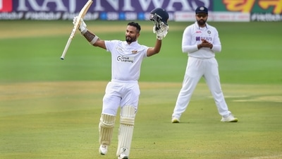 Bengaluru: Sri Lanka's batter Dimuth Karunaratne raises his bat after scoring a century during the third day of 2nd test cricket match between India and Sri Lanka at Chinnaswamy Stadium, in Bengaluru, Monday, March 14, 2022. (PTI Photo/Shailendra Bhojak)(PTI03_14_2022_000243B) (PTI)