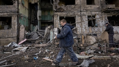 People retrieve belongings from an apartment in a block which was destroyed by an artillery strike in Kyiv, Ukraine, Monday. (AP) People retrieve belongings from an apartment in a block which was destroyed by an artillery strike in Kyiv, Ukraine, Monday. (AP)
