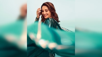 Madhuri Dixit redefined elegance as she struck poses in this green lehenga saree featuring intricate sequins work. (Instagram/@madhuridixitnene)