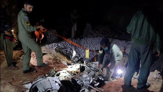 People work around the remains of a missile fired into Pakistan from India, near Mian Channu, Pakistan, on March 9, 2022. (REUTERS)