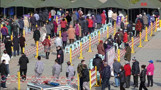 Residents queue to undergo nucleic acid tests for Covid-19 in Yantai, in China’s eastern Shandong province on Monday. (AFP)