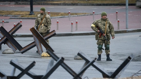Members of the Territorial Defence Force stand guard at a check point, as Russia's invasion of Ukraine continues, at the Independence Square in central Kyiv, Ukraine.