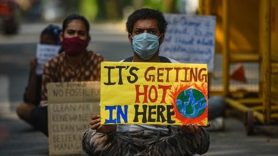 Activists with placards take part in a protest against climate change outside the Ministry of Environment in New Delhi earlier. (Amal KS/HT PHOTO.)