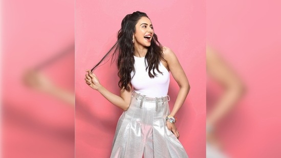 Rakul Preet gave a playful pose to the camera by looking away from the lens and posing with one hand on her hips and the other holding a strand of her hair and giving a jolly expression.(Instagram/@rakulpreet)