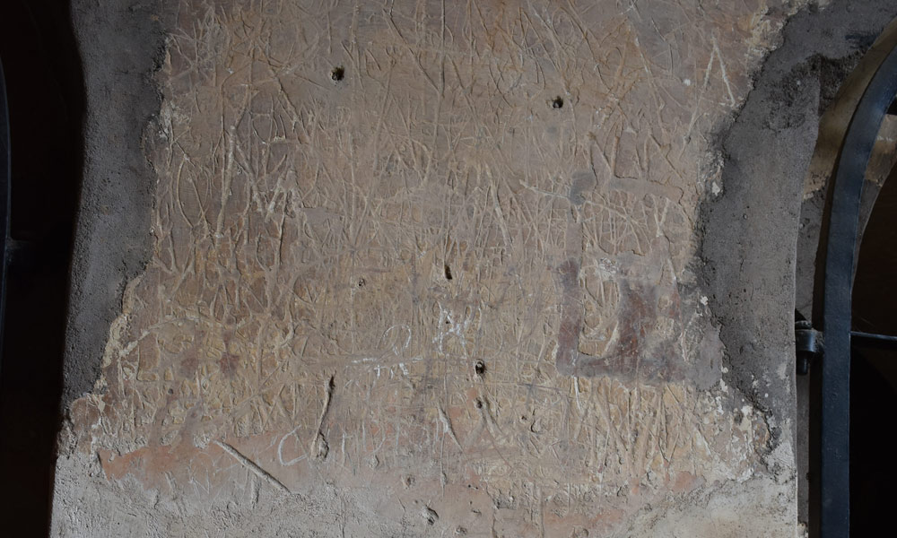 The walls of the fort are scratched and damaged