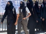 Students walk back home after being denied entry with hijab at a college in Shivamogga on February 28.