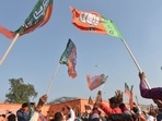 BJP supporters wave party flags in Uttar Pradesh. (PTI) BJP supporters wave party flags in Uttar Pradesh. (PTI)