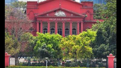 People walk in front of the Karnataka High Court, in Bengaluru, Tuesday, (PTI) People walk in front of the Karnataka High Court, in Bengaluru, Tuesday, (PTI)