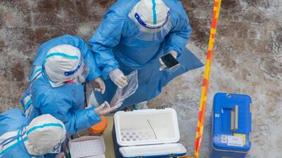Medical workers collect samples that will be tested for Covid-19 in Jilin in China’s northeastern Jilin province on Tuesday. (AFP)