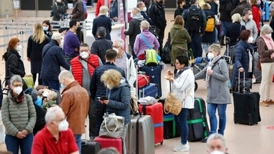 Numerous travelers wait in long lines at Hamburg Airport on Tuesday, March 15, 2022.&nbsp; (AP)