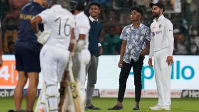 India's Virat Kohli poses for a selfie with the young boys who intruded the pitch area during the second day of the second Test match between India and Sri Lanka in Bengaluru. (AP) India's Virat Kohli poses for a selfie with the young boys who intruded the pitch area during the second day of the second Test match between India and Sri Lanka in Bengaluru. (AP)
