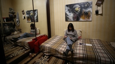 Victoria Naji, who was born in Syria to a Palestinian father and a Ukrainian mother, sits in her room in Damascus, Syria. (REUTERS)