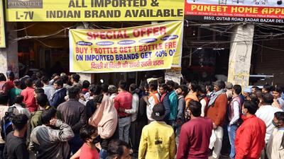 People stand before liquor shop in Delhi on February 16, after local vendors announced huge discounts. (Rahul Singh/ANI) People stand before liquor shop in Delhi on February 16, after local vendors announced huge discounts. (Rahul Singh/ANI)