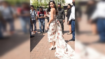 Nora Fatehi wore white pumps and accessorised her look with a pair of diamond earrings. (HT Photo/Varinder Chawla)