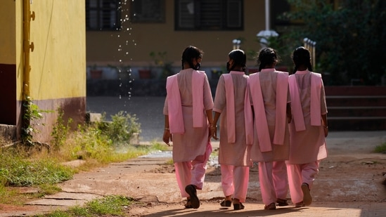 Students in uniform clothing walk inside the campus of a government-run junior college in Udupi, Karnataka. (AP)