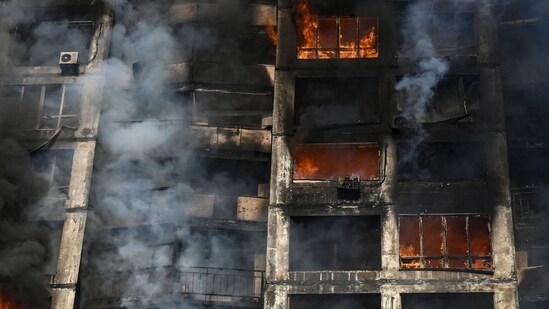 Firefighters extinguish a fire in an apartment building in Kyiv after strikes on residential areas killed at least two people,&nbsp;(AFP)