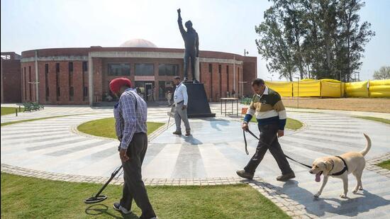Security personnel with metal detectors and a dog inspect the venue where AAP's Punjab CM-designate Bhagwant Mann will take oath as Punjab chief minister at Khatkar Kalan, the birthplace of Shaheed Bhagat Singh, in Nawanshahr near Jalandhar, on Tuesday. (PTI)