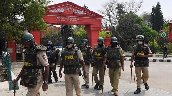 Police in front of the high court after it upheld the ban on the hijab in classrooms. (AFP)