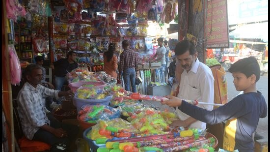 People busy buying for the Holi festival in Prayagraj. (ht photo)