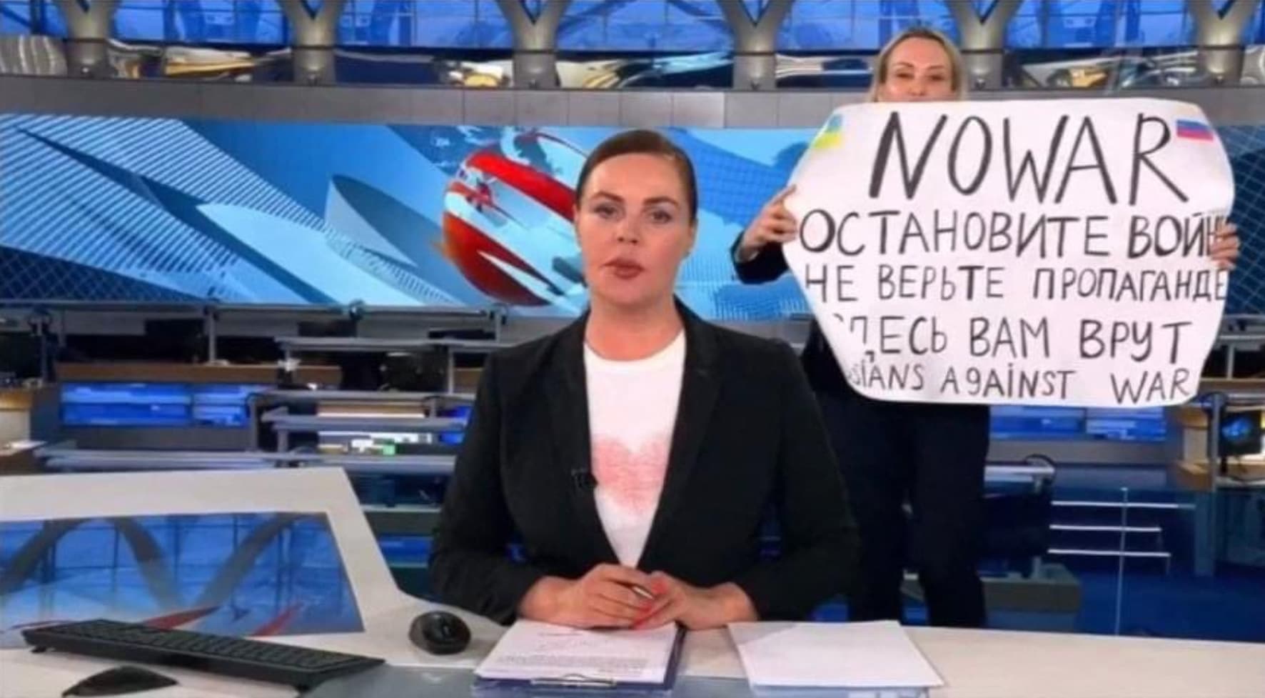 As video grab taken on March 15 showing Russian Channel One editor Marina Ovsyannikova holding a poster reading ‘Stop the war…’. (AFP)