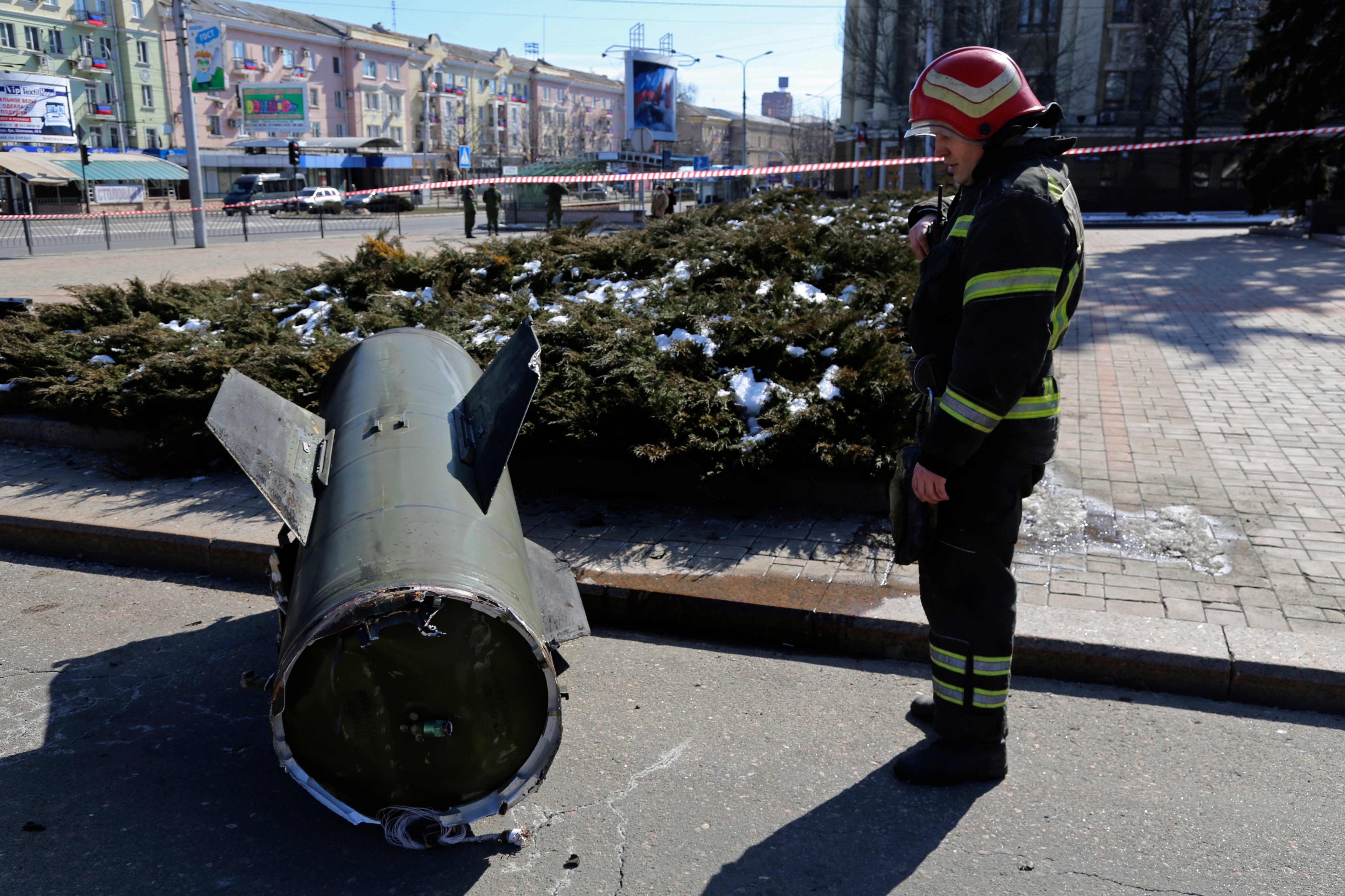 A firefighter looks at a fragment of a Ukrainian Tochka-U missile on a street in Donetsk in eastern Ukraine, Monday, March 14, 2022. (AP)