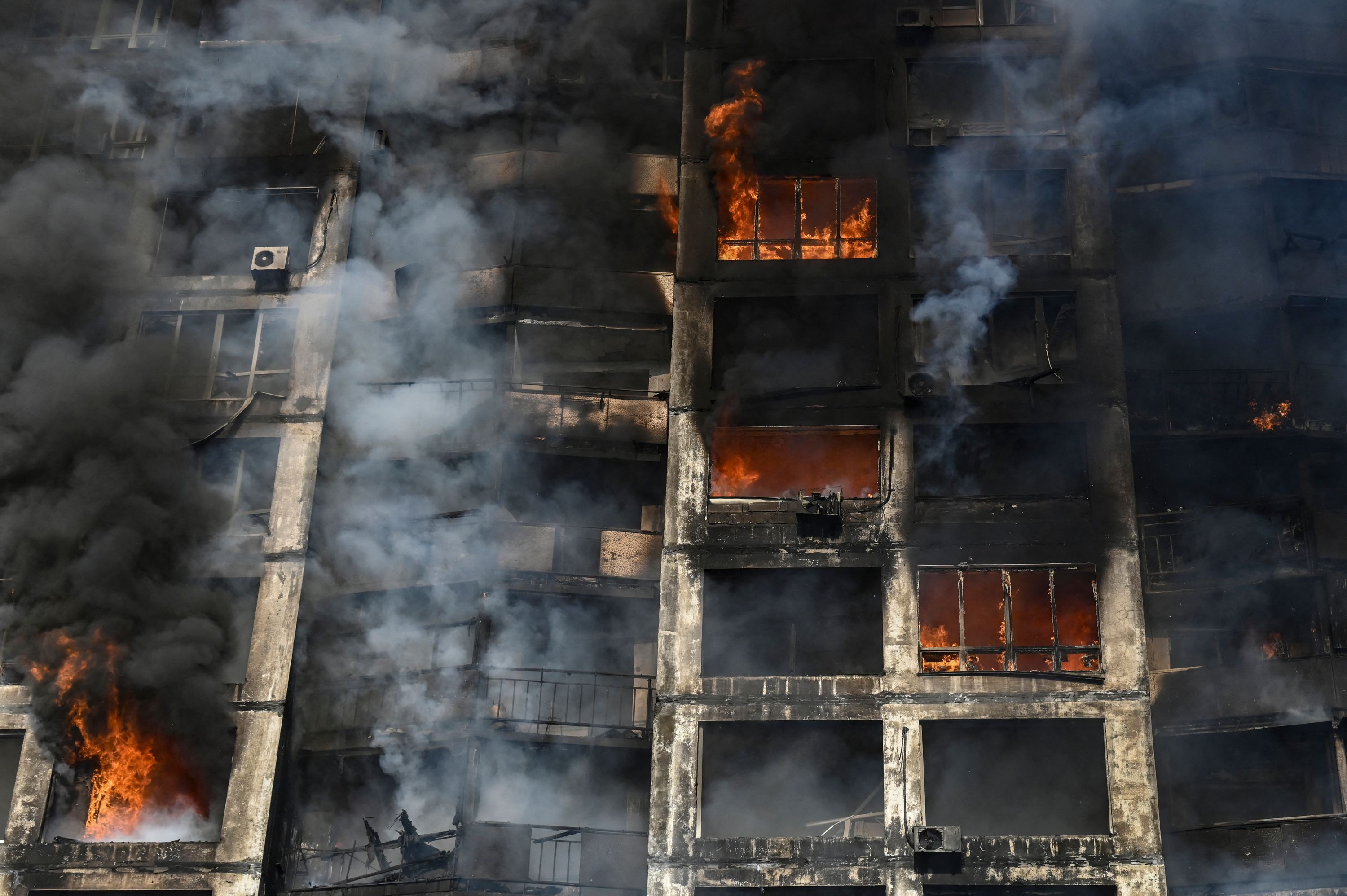 Firefighters extinguish a fire in an apartment building in Kyiv after strikes on residential areas killed at least two people,&nbsp; (AFP)