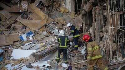 Firefighters work by a destroyed apartment building in Kharkiv, Ukraine, on Wednesday. (AP)