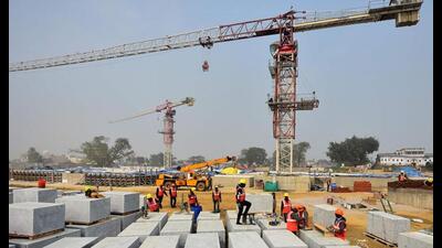 Labourers and engineers work on stone blocks at the under-construction temple site in Ayodhya. (AFP Photo)