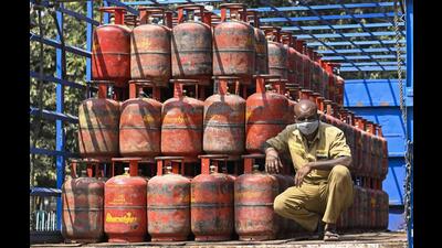 A worker sits inside a lorry, stacked with LPG cylinders . (PT Phto) A worker sits inside a lorry, stacked with LPG cylinders . (PT Phto)