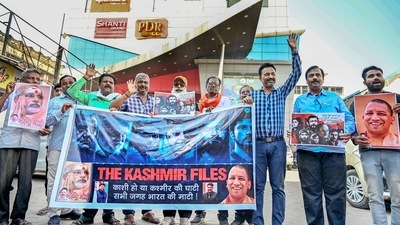 BJP supporters demonstrate outside a cinema hall in support of the film 'The Kashmir Files', at Godowlia in Varanasi. (PTI)