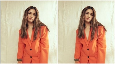 Styled by fashion stylist Sanam Ratansi, Tamannaah wore her long tresses open in wavy curls with a middle part. (Instagram/@tamannaahspeaks)