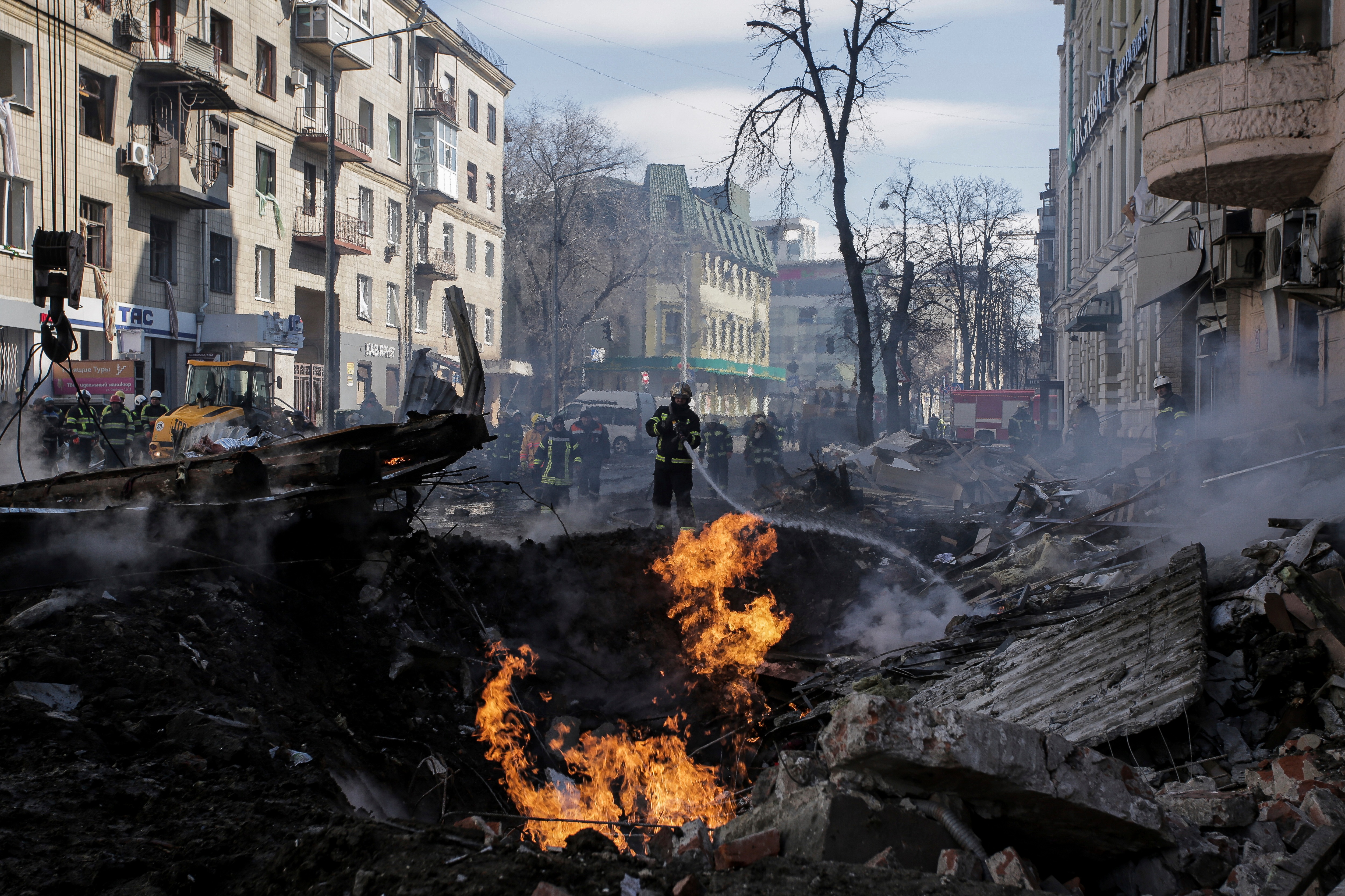 Firefighters extinguish flames outside an apartment house after a Russian rocket attack in Kharkiv, Ukraine's second-largest city on March 14, 2022. (AP)
