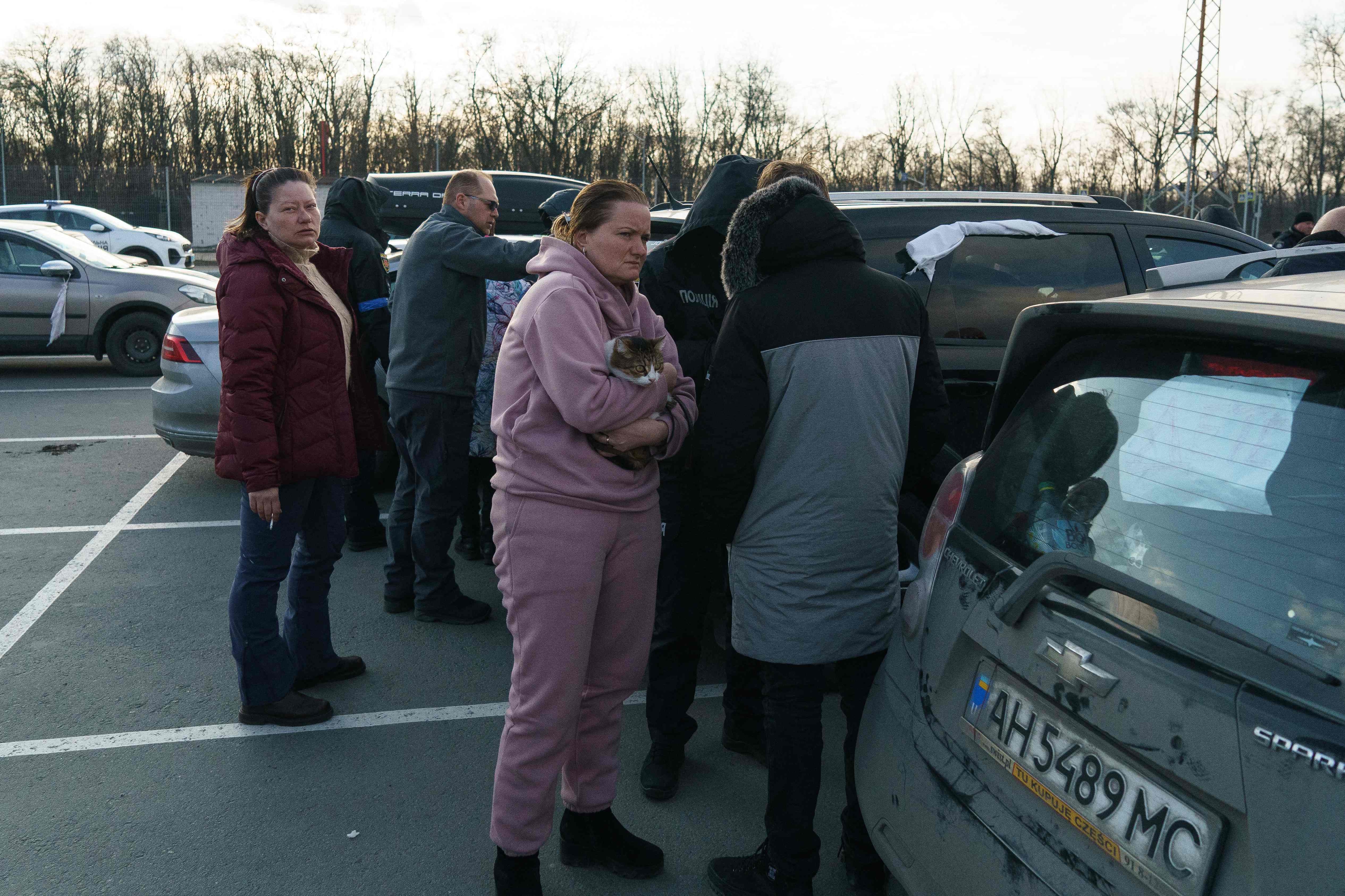 Evacuees from Mariupol are seen upon arrival at the car park of a shopping centre on the outskirts of the city of Zaporizhzhia, which is now a registration centre for displaced people, on March 15, 2022. (AFP) Evacuees from Mariupol are seen upon arrival at the car park of a shopping centre on the outskirts of the city of Zaporizhzhia, which is now a registration centre for displaced people, on March 15, 2022. (AFP)