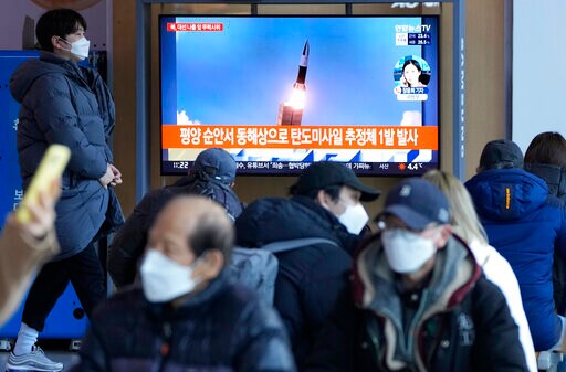 People watch a TV showing a file image of North Korea's missile launch during a news programme at the Seoul Railway Station in Seoul, South Korea, March 5, 2022. (AP Photo/Ahn Young-joon, File)