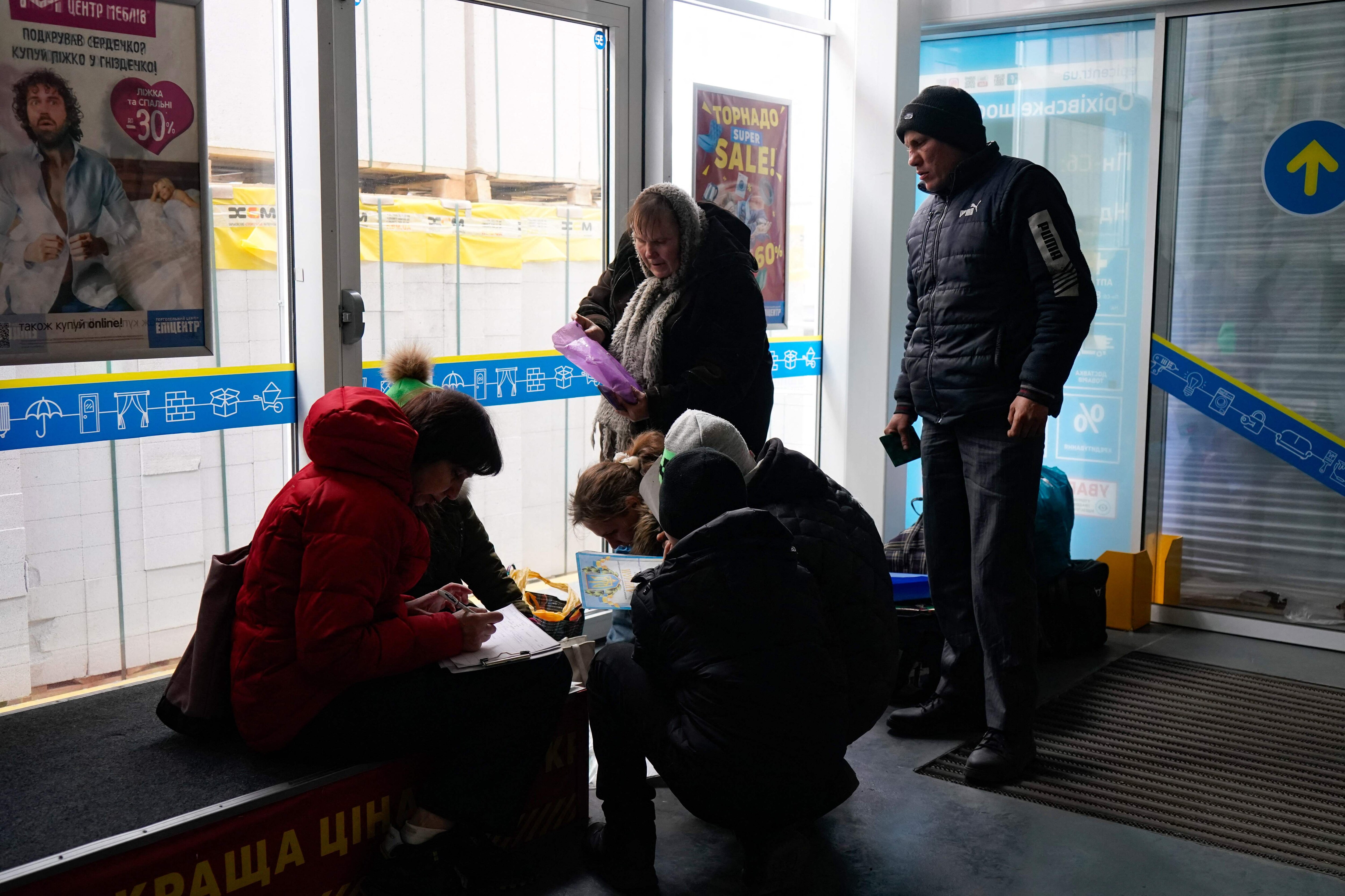 Evacuees from Mariupol are seen at a shopping centre on the outskirts of the city of Zaporizhzhia, which is now a registration centre for displaced people, on March 16, 2022. (Photo by Emre CAYLAK/AFP) Evacuees from Mariupol are seen at a shopping centre on the outskirts of the city of Zaporizhzhia, which is now a registration centre for displaced people, on March 16, 2022. (Photo by Emre CAYLAK/AFP)