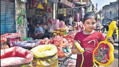 A girl stands with her water gun at a market in Ludhiana on Thursday. (Gurpreet Singh/Hindustan Times) A girl stands with her water gun at a market in Ludhiana on Thursday. (Gurpreet Singh/Hindustan Times)