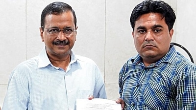 Delhi Chief Minister Arvind Kejriwal hands over a government job appointment letter to Ankur Sharma, brother of IB employee Ankit Sharma, who lost his life in Delhi violence, in New Delhi. (ANI ) Delhi Chief Minister Arvind Kejriwal hands over a government job appointment letter to Ankur Sharma, brother of IB employee Ankit Sharma, who lost his life in Delhi violence, in New Delhi. (ANI )