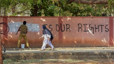 Graffiti saying ‘hijab is our rights’ is being removed in Hospet, Karnataka, (PTI) Graffiti saying ‘hijab is our rights’ is being removed in Hospet, Karnataka, (PTI)