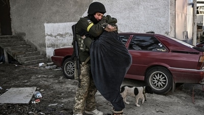 A Ukranian soldier hugs his wife in the city of Irpin, north of Kyiv. (AFP) A Ukranian soldier hugs his wife in the city of Irpin, north of Kyiv. (AFP)