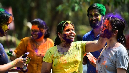 Medical students play with coloured powder as they participate in Holi celebrations inside Moti Lal Nehru Medical College campus in Allahabad.(AFP)