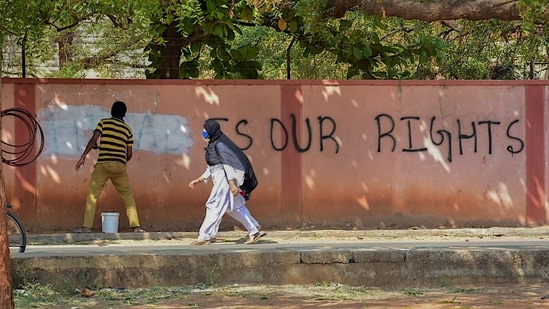 Graffiti saying ‘hijab is our rights’ is being removed in Hospet, Karnataka,&nbsp;(PTI)