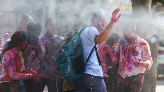 Students play with colours outside their school in New Delhi ahead of the upcoming festival of Holi.(HT Photo/Sanchit Khanna)