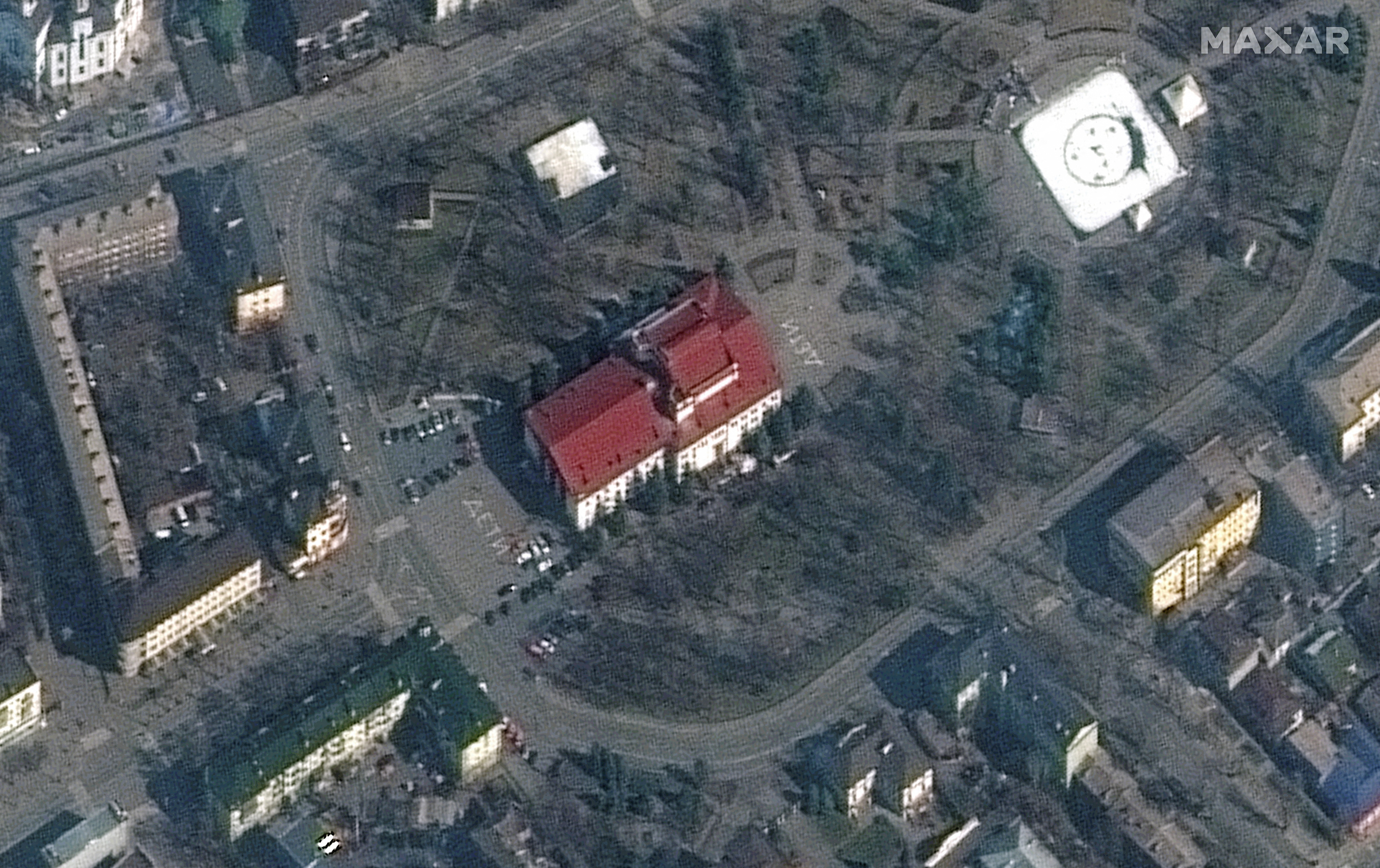 Satellite image shows closer view of Mariupol Drama Theatre before bombing, as a word "children" in Russian is written in large white letters on the pavement in front of and behind the building. Picture taken March 14, 2022. Satellite image ©2022 Maxar Technologies/Handout via REUTERS (via REUTERS)