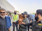 The team of RRR playing with Ram Charan's dog. The team of RRR playing with Ram Charan's dog.