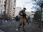 A member of the Ukrainian military surveys an area next to a residential building hit by an intercepted missile, as Russia's invasion of Ukraine continues, in Kyiv, Ukraine March 17, 2022. REUTERS/Thomas Peter